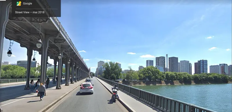 Google stree view screenshot of a road in Paris under a bridge and next to the Ile aux cygnes.