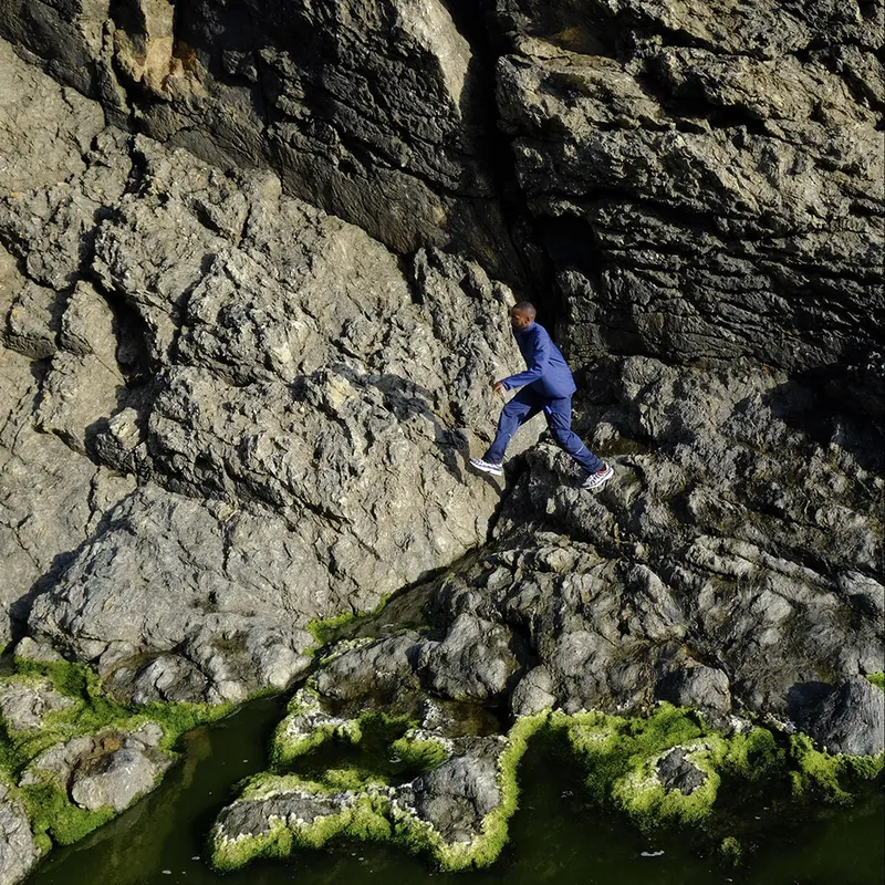 Man jumping from one rock to another