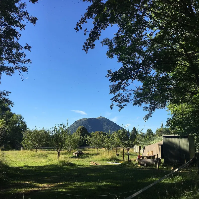 A campsite with the Puy de Dôme volcano visible in the background
