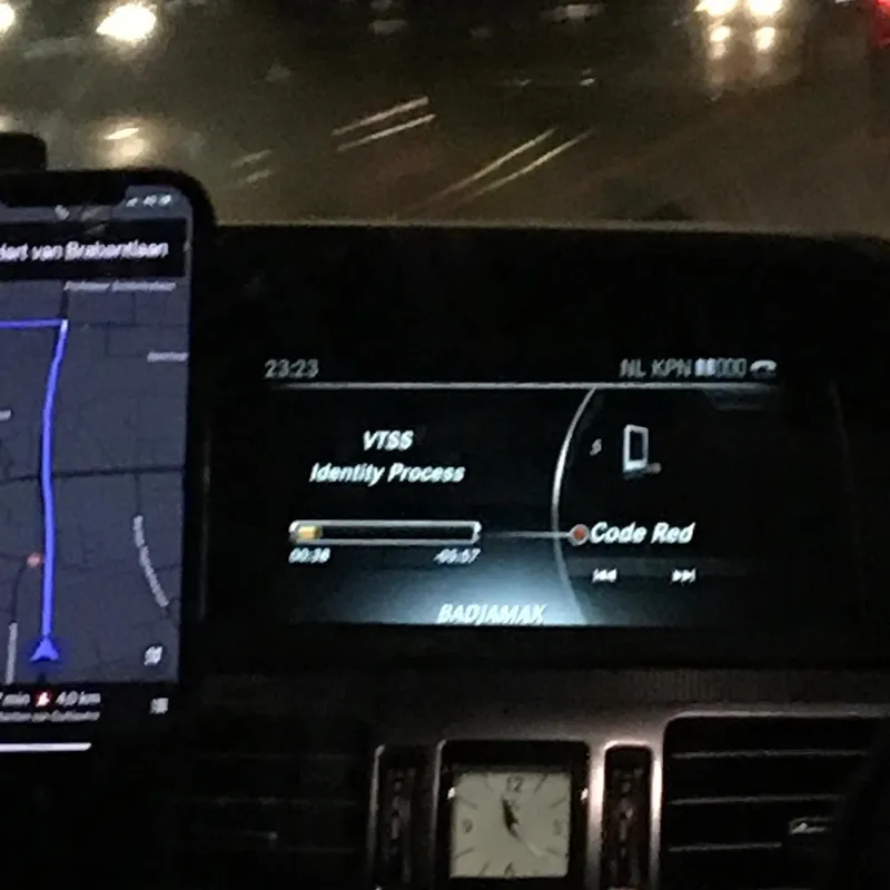 Car dashboard display showing VTSS — Identity Process playing