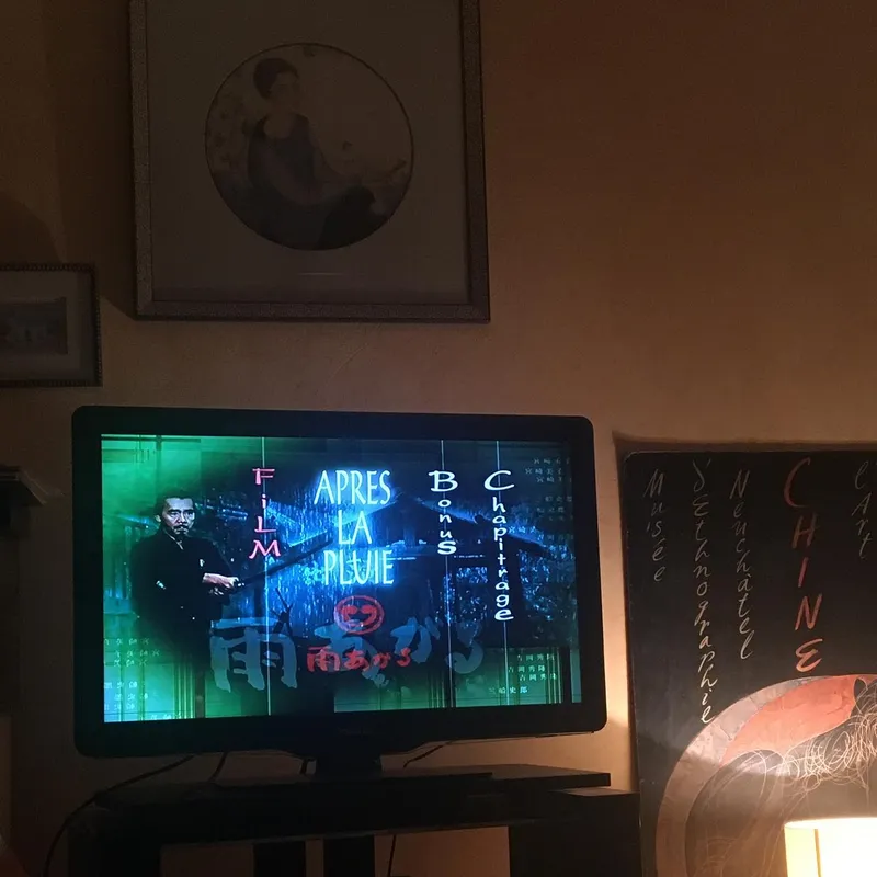 A TV screen showing the DVD menu for the Japanese film Après la Pluie