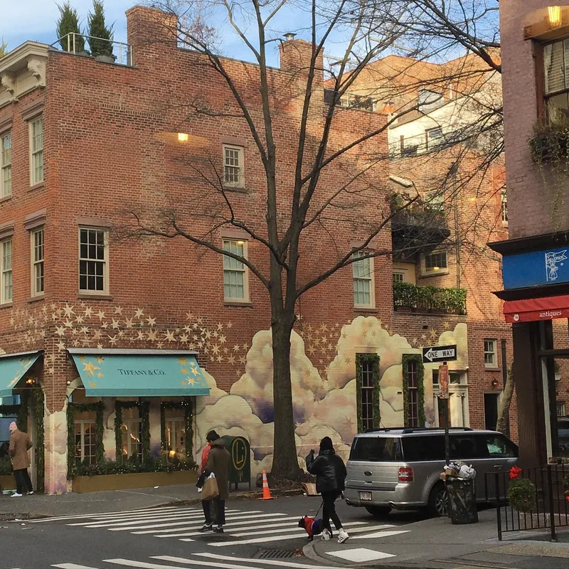 Tiffany & Co. pop-up shop with a painted cloud and stars mural on a brick building in NYC