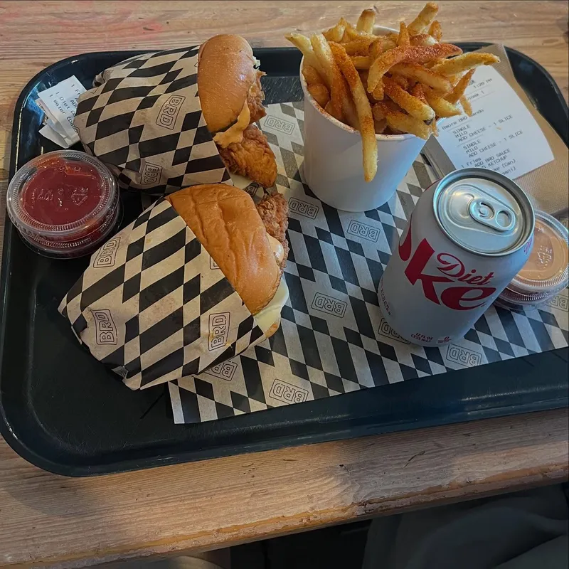A fast food tray with fried chicken sandwiches and fries