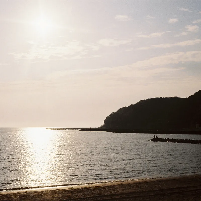 Sunset on Itoshima beach with shadows of fishermen on the pier